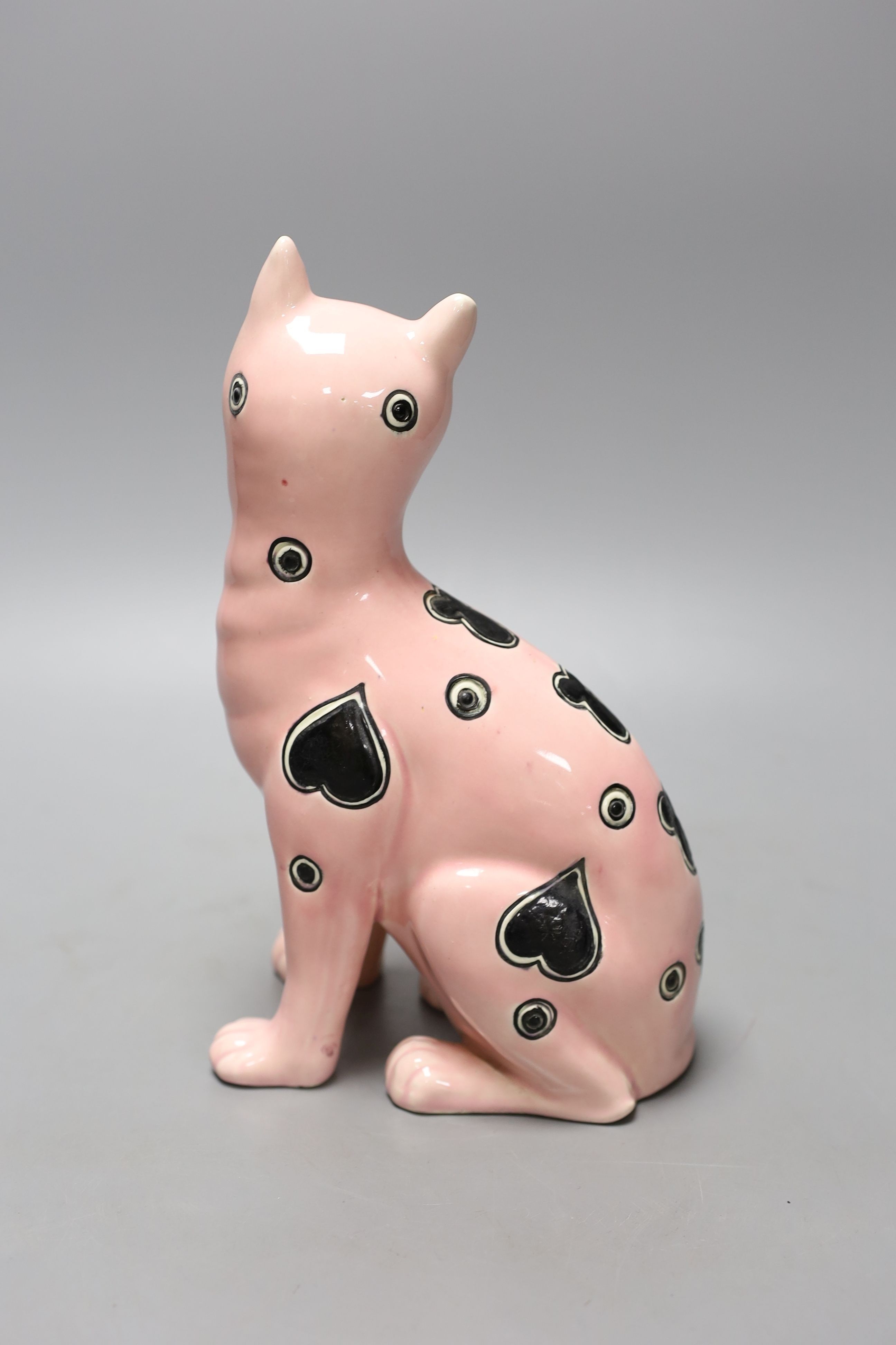 A Galle style pink glazed pottery model of a cat, early 20th century, impressed number 1896 to base, 24.5 cm high, eyes lacking